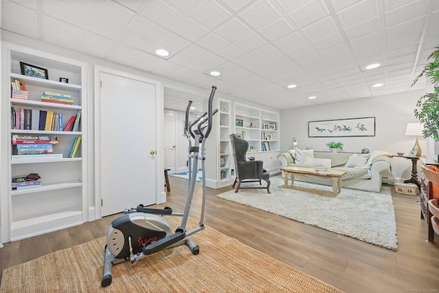 80 Ramapoo Rd, Ridgefield, CT 06877 - exercise room featuring built in shelves, wood finished floors, and recessed lighting