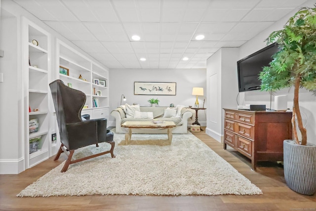 80 Ramapoo Rd, Ridgefield, CT 06877 - living room featuring wood finished floors, recessed lighting, and built in shelves