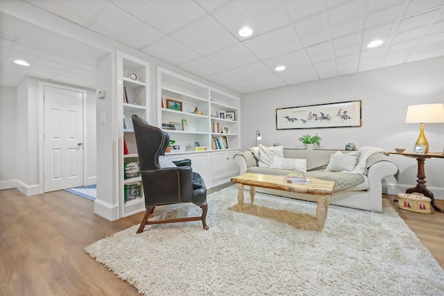 80 Ramapoo Rd, Ridgefield, CT 06877 - living area featuring wood finished floors, baseboards, built in shelves, and recessed lighting