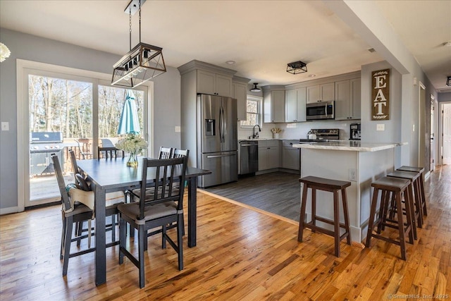 dining space with baseboards, a notable chandelier, and wood finished floors