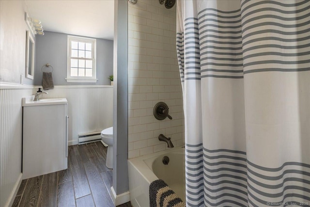 full bath with toilet, vanity, wood finished floors, a baseboard radiator, and wainscoting