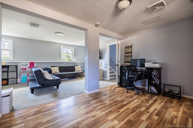 office area with wood finished floors, baseboards, and visible vents
