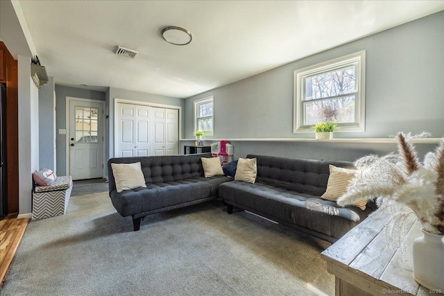 carpeted living room featuring visible vents