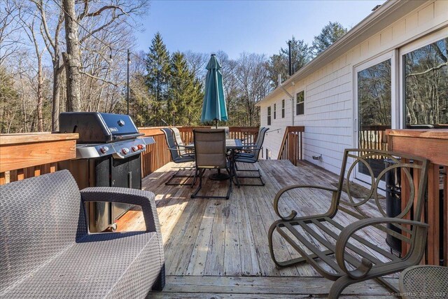 wooden terrace with outdoor dining space