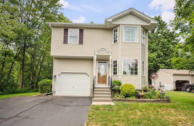 32 Pheasant Hill Dr Unit 32, Enfield, CT 06082 - view of front of home featuring a front lawn, driveway, an attached garage, and entry steps