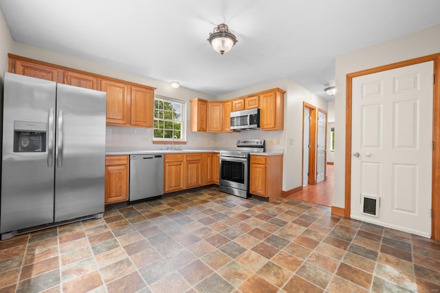 32 Pheasant Hill Dr Unit 32, Enfield, CT 06082 - kitchen with appliances with stainless steel finishes, stone finish flooring, and light countertops