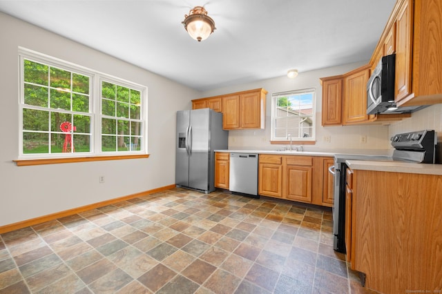 32 Pheasant Hill Dr Unit 32, Enfield, CT 06082 - kitchen featuring appliances with stainless steel finishes, stone finish flooring, light countertops, and backsplash