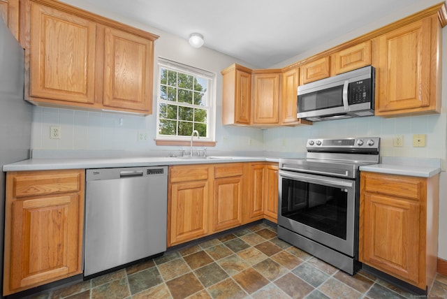32 Pheasant Hill Dr Unit 32, Enfield, CT 06082 - kitchen featuring appliances with stainless steel finishes, dark stone finish flooring, backsplash, and light countertops