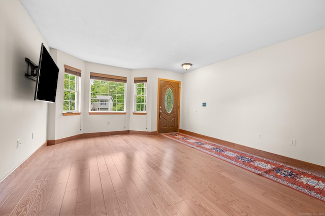 32 Pheasant Hill Dr Unit 32, Enfield, CT 06082 - unfurnished living room with light wood finished floors and baseboards