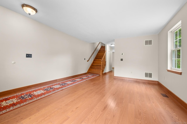 32 Pheasant Hill Dr Unit 32, Enfield, CT 06082 - unfurnished living room with light wood finished floors and stairway