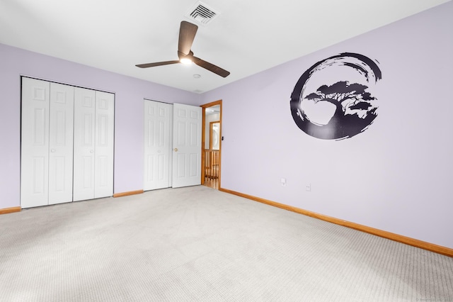 32 Pheasant Hill Dr Unit 32, Enfield, CT 06082 - unfurnished bedroom featuring multiple closets, light carpet, and ceiling fan