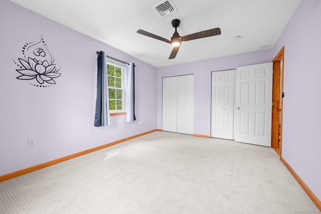 32 Pheasant Hill Dr Unit 32, Enfield, CT 06082 - unfurnished bedroom featuring two closets, light carpet, and a ceiling fan