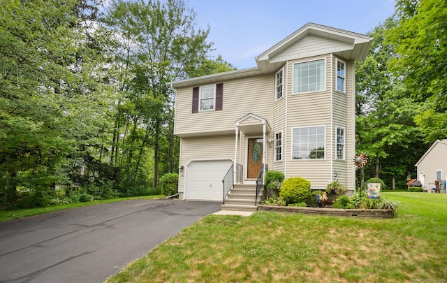 32 Pheasant Hill Dr Unit 32, Enfield, CT 06082 - view of front facade with a garage, asphalt driveway, and a front lawn