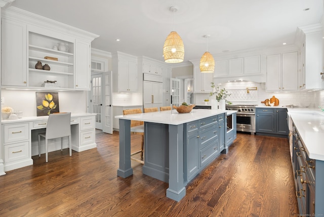 kitchen with high end appliances, white cabinets, blue cabinetry, gray cabinetry, and recessed lighting