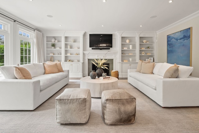 living area with a premium fireplace, ornamental molding, recessed lighting, and built in features