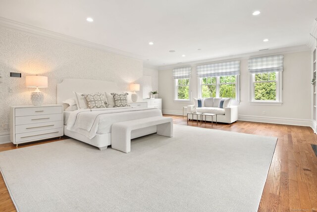 bedroom with crown molding, light wood-style floors, recessed lighting, and baseboards