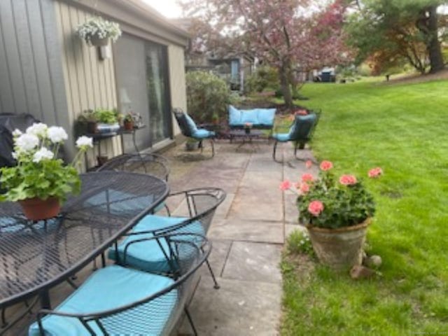 view of patio / terrace featuring outdoor dining space and an outdoor hangout area