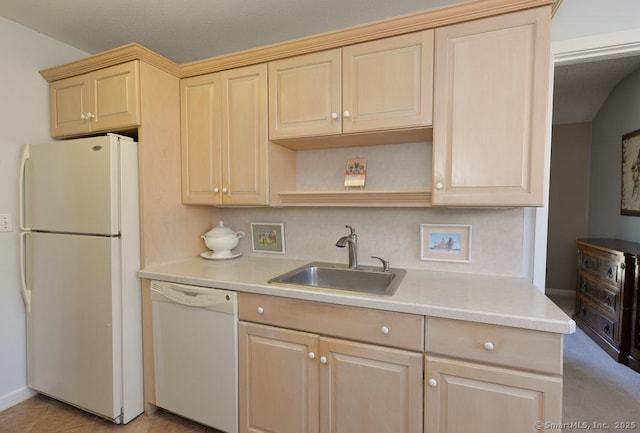 kitchen with white appliances, light tile patterned floors, light brown cabinetry, a sink, and light countertops
