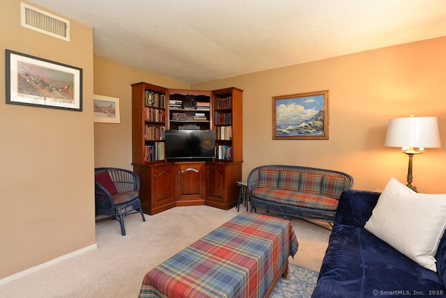 living room featuring carpet flooring, baseboards, visible vents, and a textured ceiling