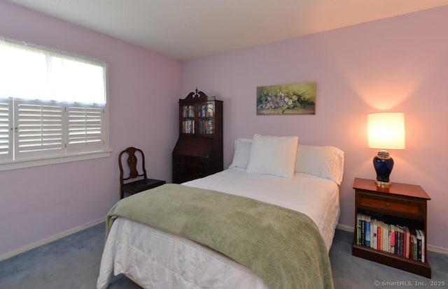 carpeted bedroom featuring baseboards