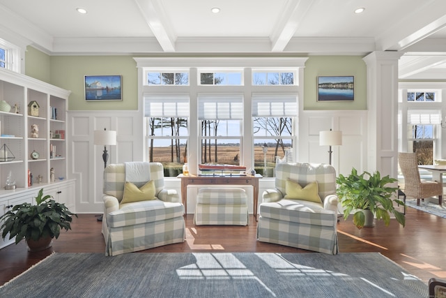 sunroom featuring beam ceiling and a healthy amount of sunlight