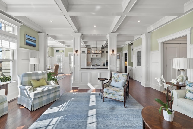 living room with coffered ceiling, a wealth of natural light, dark wood-style flooring, and decorative columns