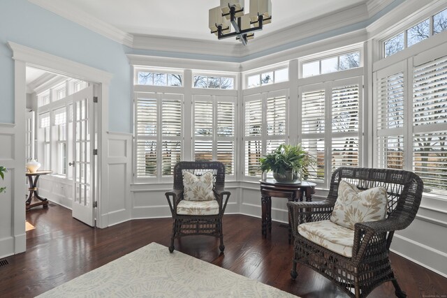 sunroom with french doors and a chandelier