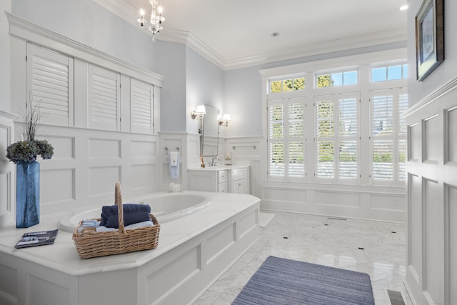 full bathroom featuring wainscoting, vanity, ornamental molding, and a decorative wall