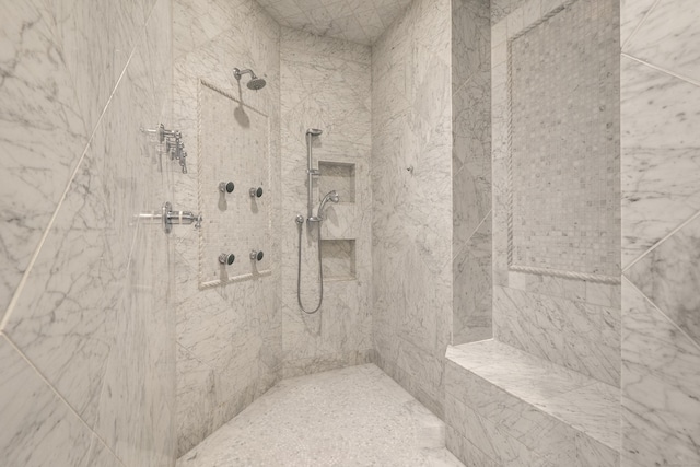 full bathroom featuring tiled shower