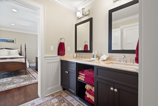 full bathroom featuring connected bathroom, crown molding, and a sink