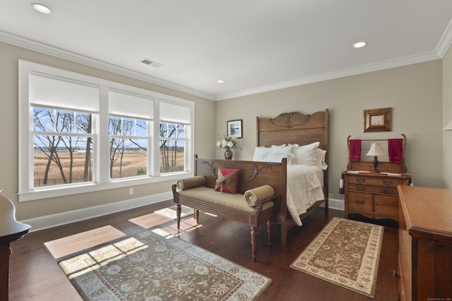 bedroom with ornamental molding, wood finished floors, and visible vents