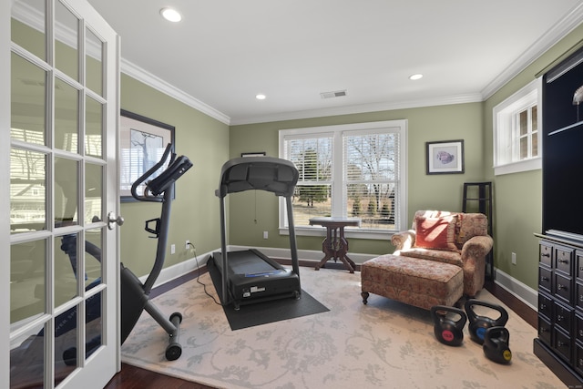 exercise area featuring crown molding, wood finished floors, baseboards, visible vents, and recessed lighting
