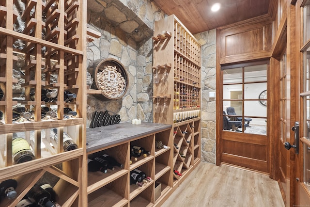 wine area featuring wood ceiling and wood finished floors