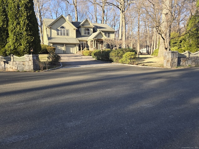 16 Fullmar Ln, Norwalk, CT 06850 - view of front of property featuring asphalt driveway, a chimney, and a garage