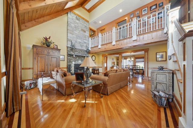 16 Fullmar Ln, Norwalk, CT 06850 - living room featuring high vaulted ceiling, light wood-style floors, beam ceiling, stairway, and a chandelier