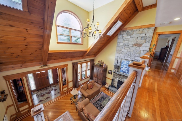 16 Fullmar Ln, Norwalk, CT 06850 - living room featuring a chandelier, wood finished floors, a fireplace, high vaulted ceiling, and beam ceiling
