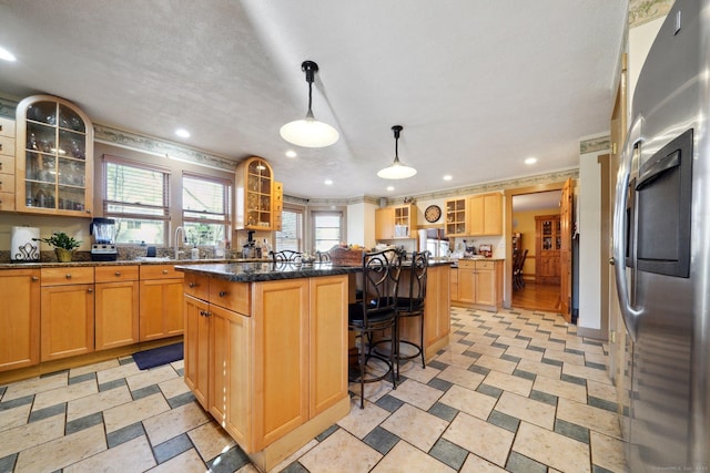 16 Fullmar Ln, Norwalk, CT 06850 - kitchen with freestanding refrigerator, a center island, a breakfast bar, glass insert cabinets, and recessed lighting