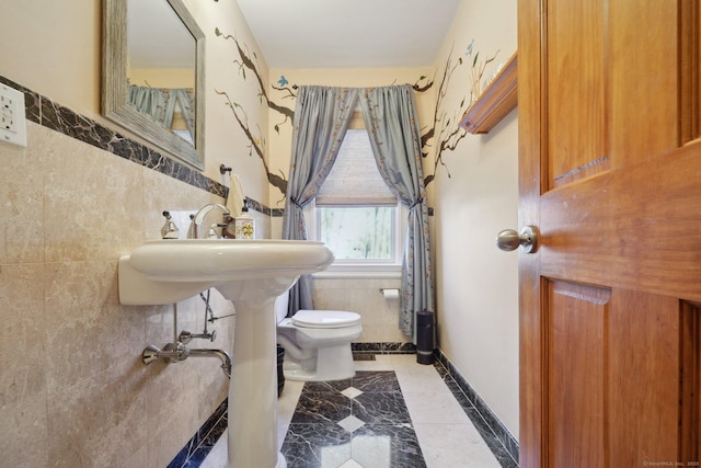 16 Fullmar Ln, Norwalk, CT 06850 - half bathroom with tile walls, inlaid floor details, wainscoting, and tile patterned flooring