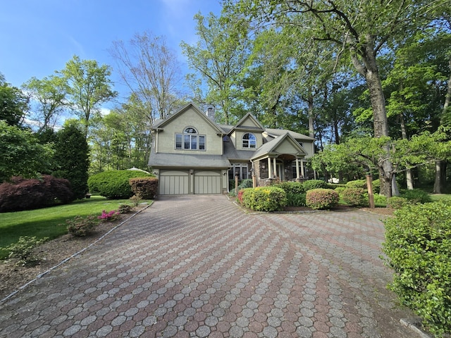 16 Fullmar Ln, Norwalk, CT 06850 - shingle-style home with an attached garage, decorative driveway, and a chimney