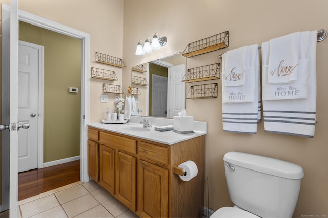 bathroom featuring tile patterned floors, toilet, and vanity