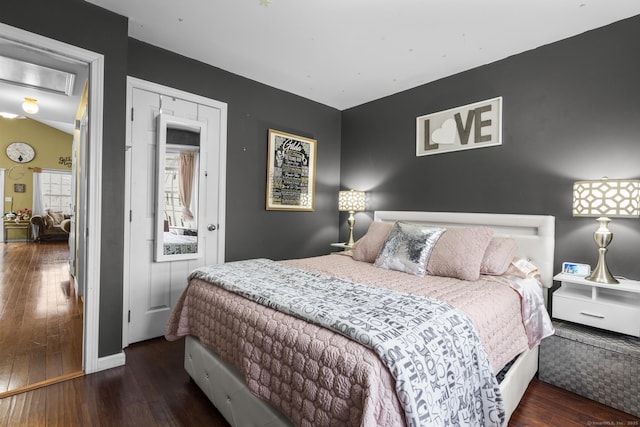bedroom with hardwood / wood-style flooring and baseboards