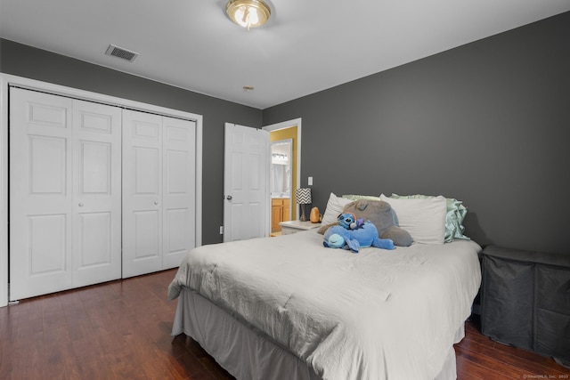 bedroom featuring visible vents, a closet, and dark wood-style floors