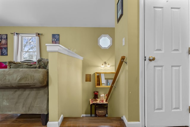 stairway with baseboards and wood finished floors