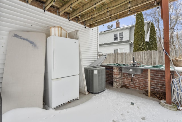 view of patio / terrace featuring cooling unit and fence