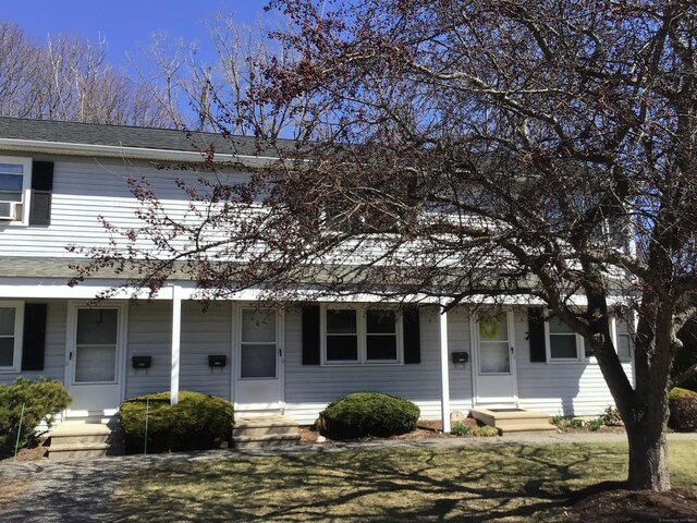 view of front of home with roof with shingles and entry steps