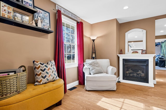 106 Chesterfield Rd, East Lyme, CT 06333 - living area featuring wood finished floors, baseboards, a glass covered fireplace, and recessed lighting