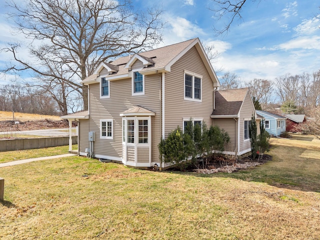 106 Chesterfield Rd, East Lyme, CT 06333 - view of property exterior featuring roof with shingles and a lawn
