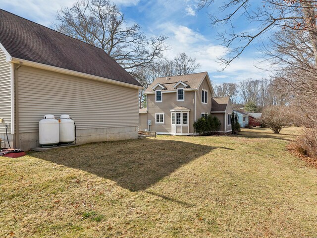 106 Chesterfield Rd, East Lyme, CT 06333 - back of house with a lawn and a shingled roof