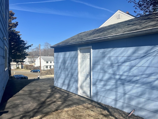 view of property exterior featuring a shingled roof