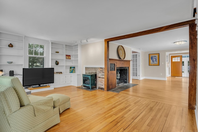 387 N River St, Guilford, CT 06437 - living room featuring a fireplace with flush hearth, light wood-style flooring, built in features, track lighting, and baseboards